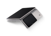 A modern silver conference phone with a touchscreen display, laying on its side.