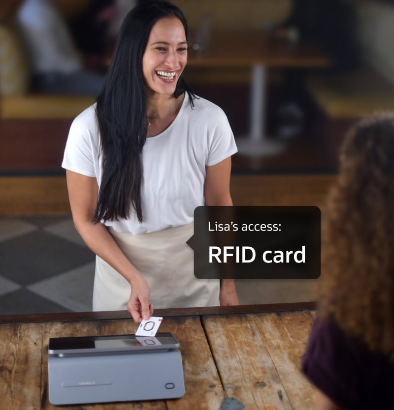 A woman is smiling while scanning an RFID card on a counter device. The text on the image reads, "Lisa's access: RFID card.