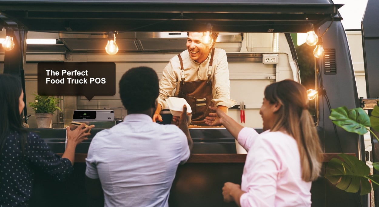 A food truck vendor hands a meal to a customer while another customer waits. A sign above reads "The Perfect Food Truck POS." The scene is illuminated with warm, hanging lights.